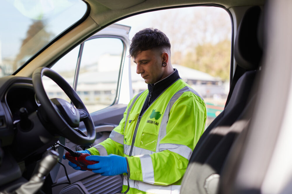 Green flag technician in a vehicle running tests
