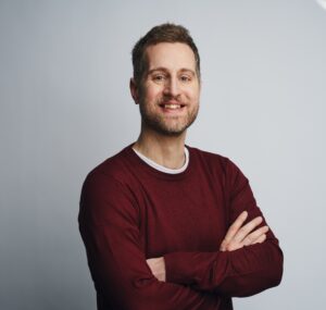 chris standing with arms folded