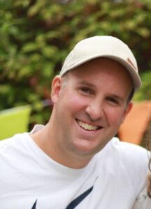 Adam wearing a white cap